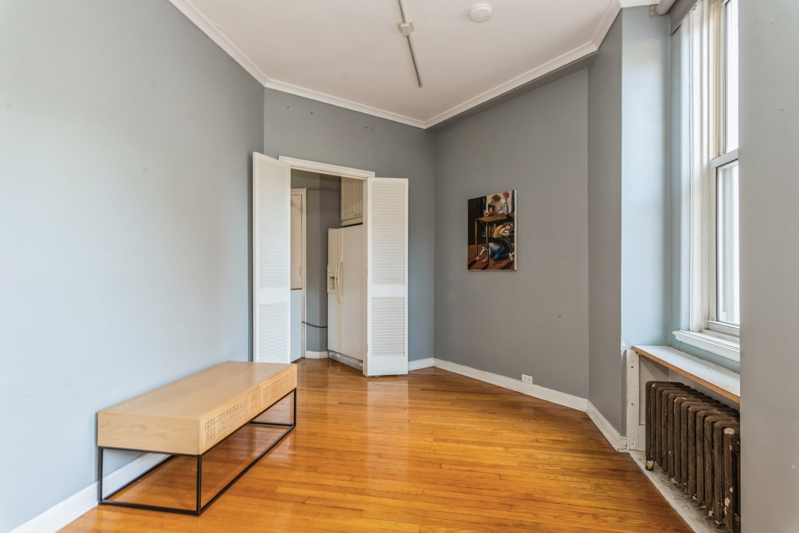 5555 North Sheridan Road, Unit 131 Chicago, IL 60640 - Photo 6 of 24 a bedroom with a bed and wooden floor