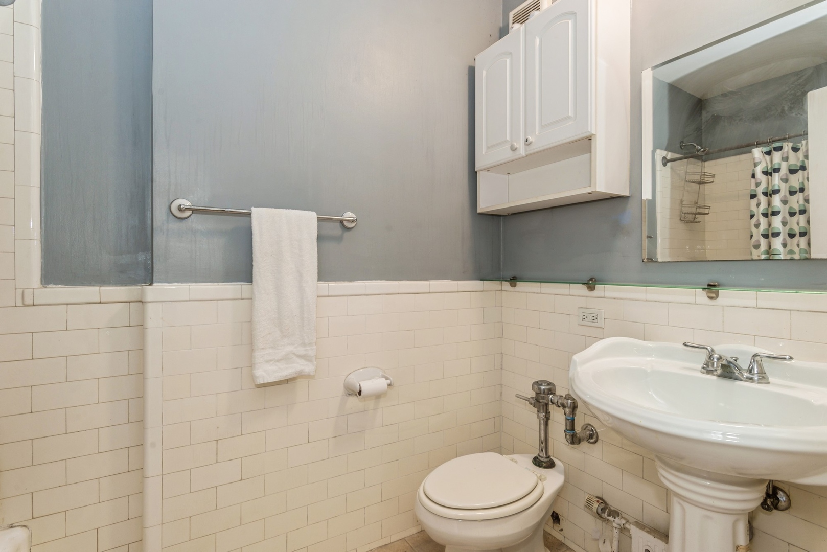 5555 North Sheridan Road, Unit 131 Chicago, IL 60640 - Photo 9 of 24 a bathroom with a sink a toilet and mirror