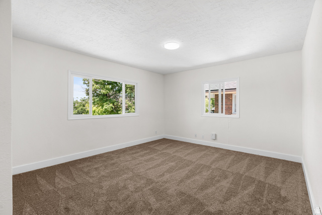 2862 Fowler Avenue Ogden, UT 84403 - Photo 8 of 23 Spacious room featuring neutral carpeting, white walls, and bright white trim