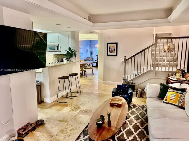 a view of a dining room with furniture and a chandelier
