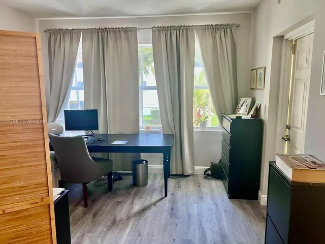 a bedroom with a bed and painting on the wall