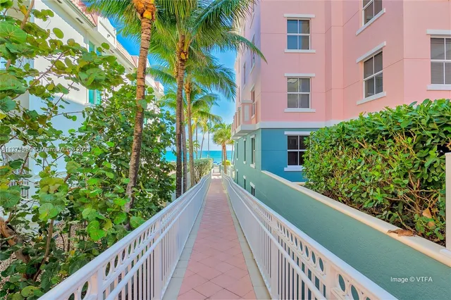 a palm tree sitting on a sidewalk next to a road