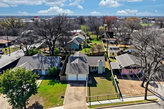 an aerial view of a house with a swimming pool and lake view