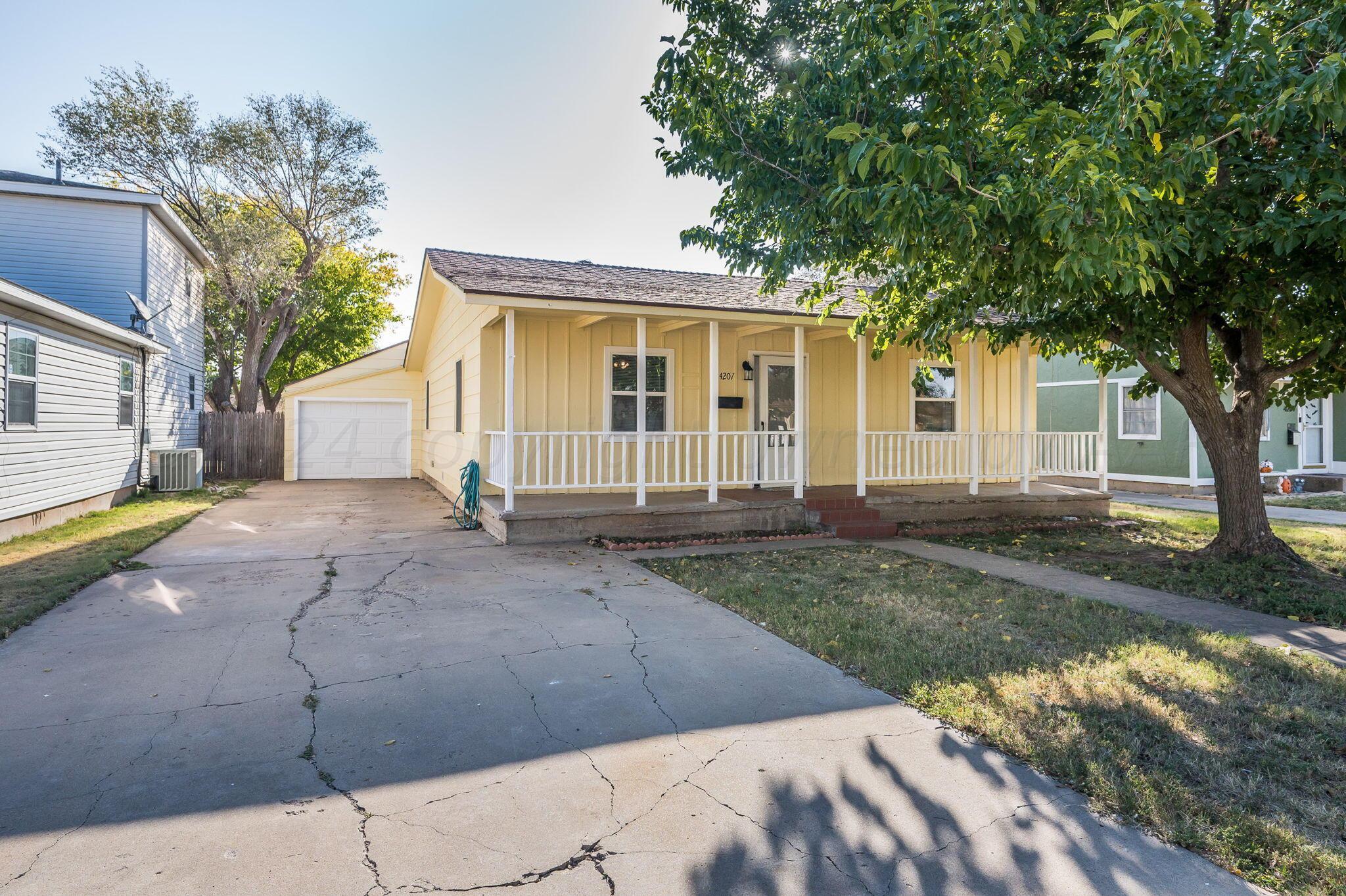 4207 South Ong Street Amarillo, TX 79110 - Photo 1 of 16 a view of a house with backyard and a tree