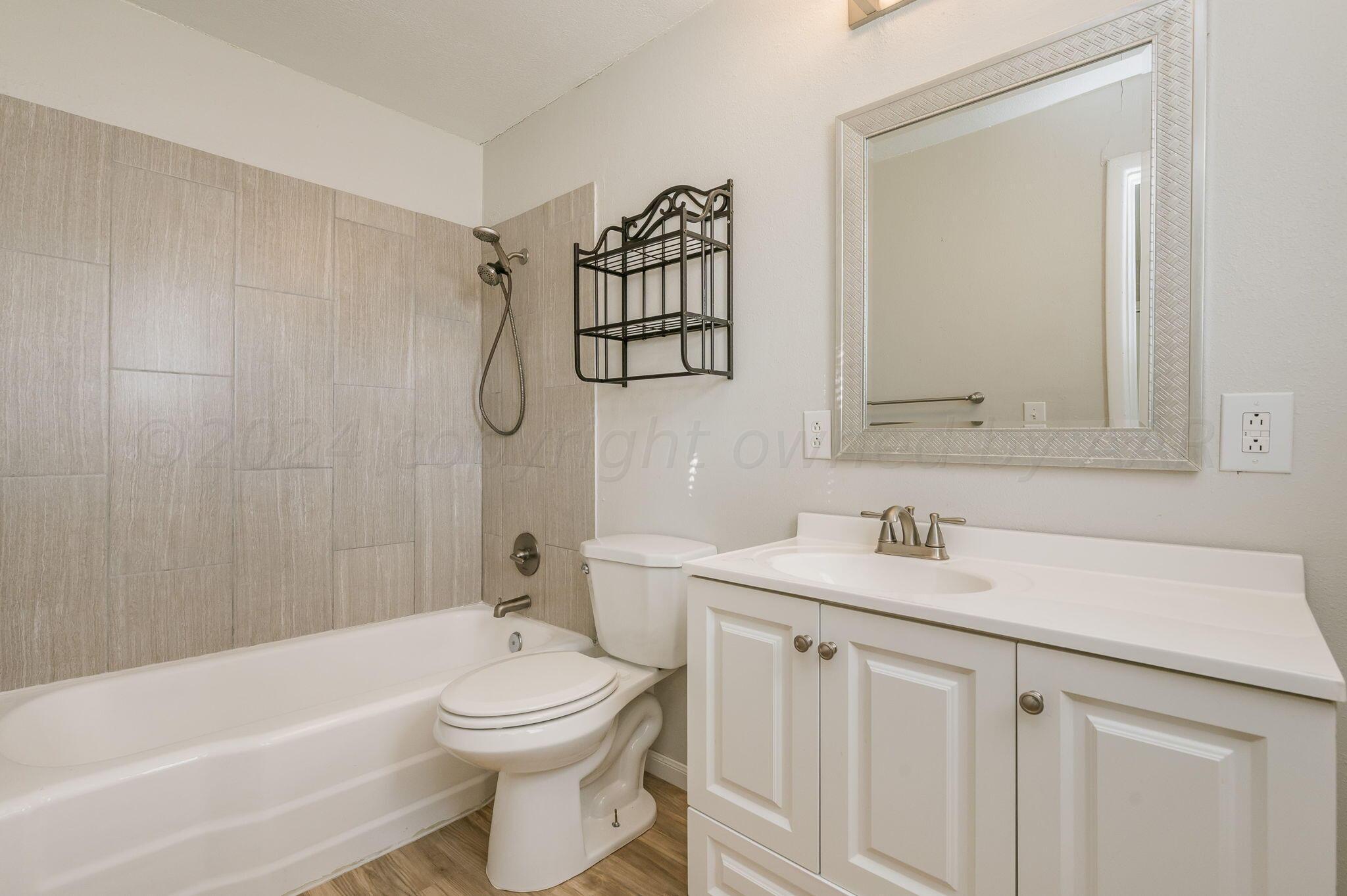 4207 South Ong Street Amarillo, TX 79110 - Photo 14 of 16 a bathroom with a sink a toilet and shower
