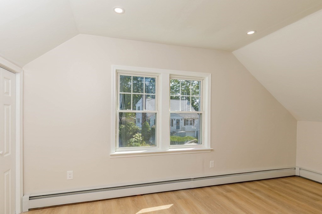4 Everton Avenue Worcester, MA 01604 - Photo 16 of 26 an empty room with wooden floor and windows