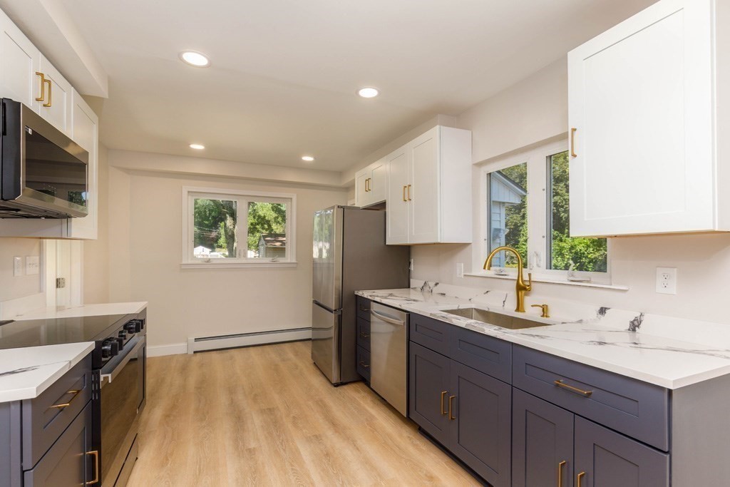 4 Everton Avenue Worcester, MA 01604 - Photo 2 of 26 a kitchen with a sink stove and cabinets