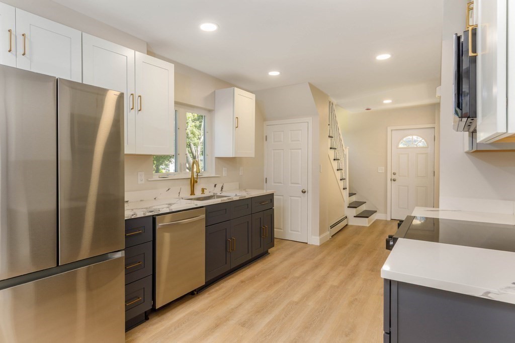 4 Everton Avenue Worcester, MA 01604 - Photo 3 of 26 a large kitchen with stainless steel appliances a refrigerator and a sink