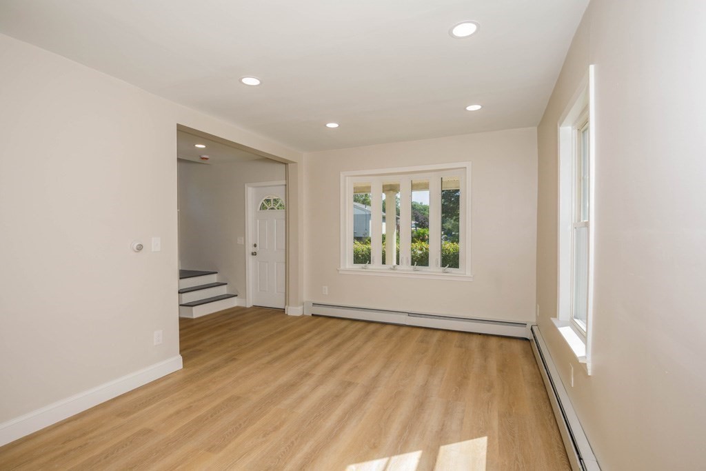 4 Everton Avenue Worcester, MA 01604 - Photo 5 of 26 an empty room with wooden floor and windows