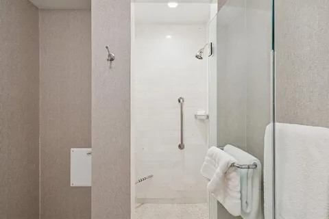 a bedroom with a large bed and a window