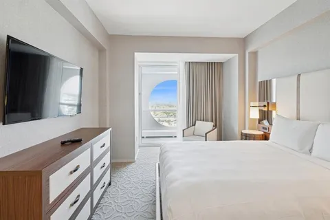 a view of a balcony with wooden floor and city view