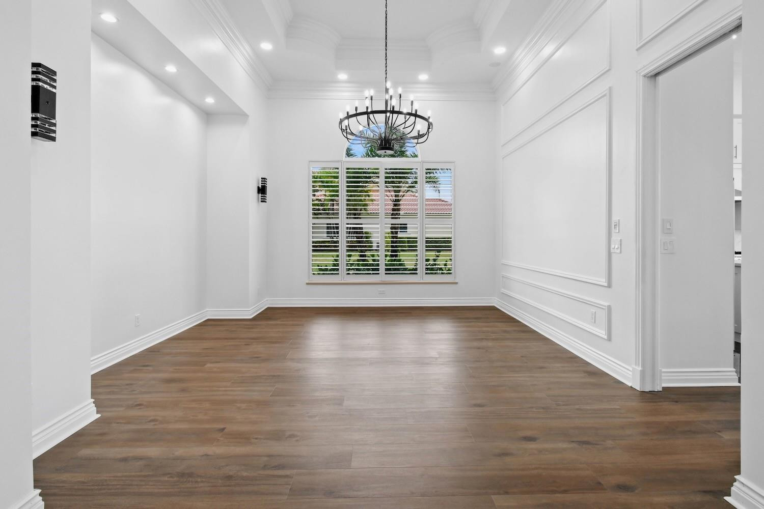128 Southeast Rio Angelica Port St. Lucie, FL 34984 - Photo 14 of 40 a view of an empty room with wooden floor and a window