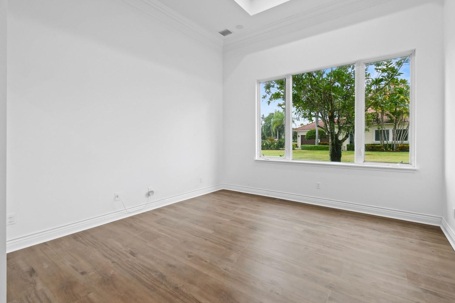 128 Southeast Rio Angelica Port St. Lucie, FL 34984 - Photo 16 of 40 an empty room with wooden floor and windows