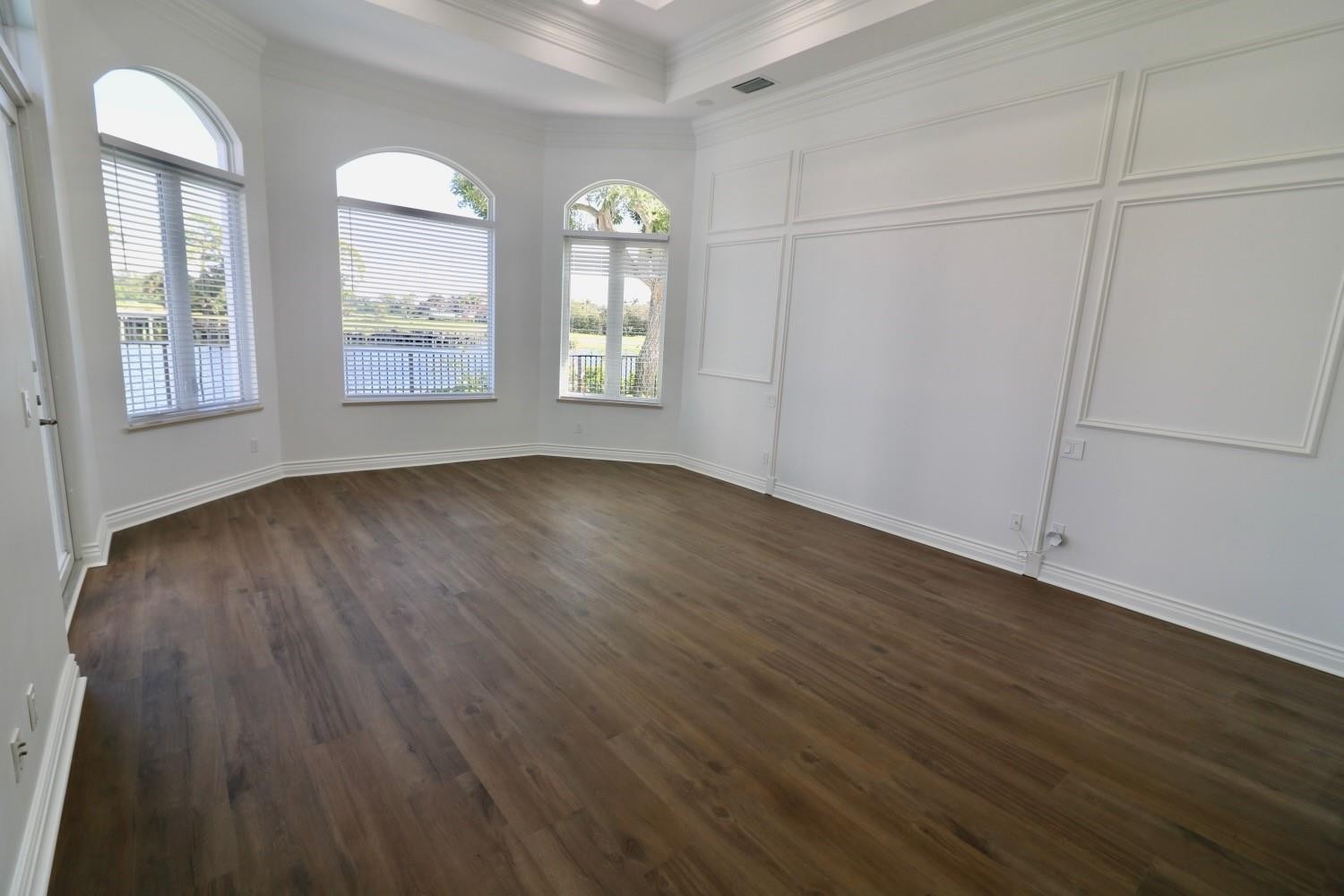 128 Southeast Rio Angelica Port St. Lucie, FL 34984 - Photo 19 of 40 an empty room with wooden floor and windows