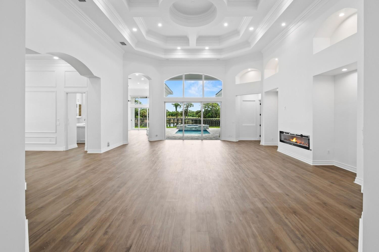 128 Southeast Rio Angelica Port St. Lucie, FL 34984 - Photo 6 of 40 an empty room with wooden floor and windows