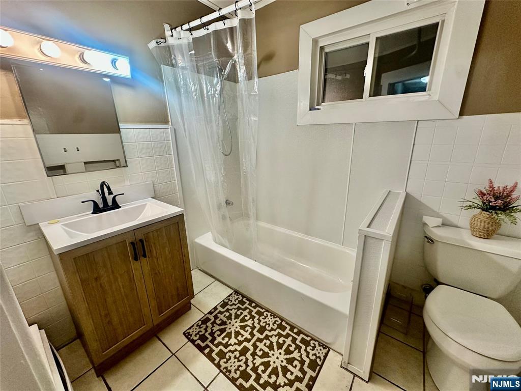 546 Victory Avenue, Unit 2 Ridgefield, NJ 07657 - Photo 13 of 14 a bathroom with a sink toilet and shower