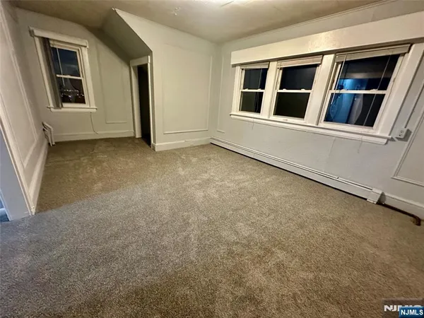 a view of an empty room with chandelier