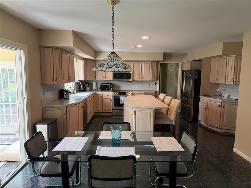 4114 Rochelle Drive Allentown, PA 18104 - Photo 16 of 35 A well-appointed kitchen features ample cabinetry, an eat-in island, and direct access to outdoor spaces.