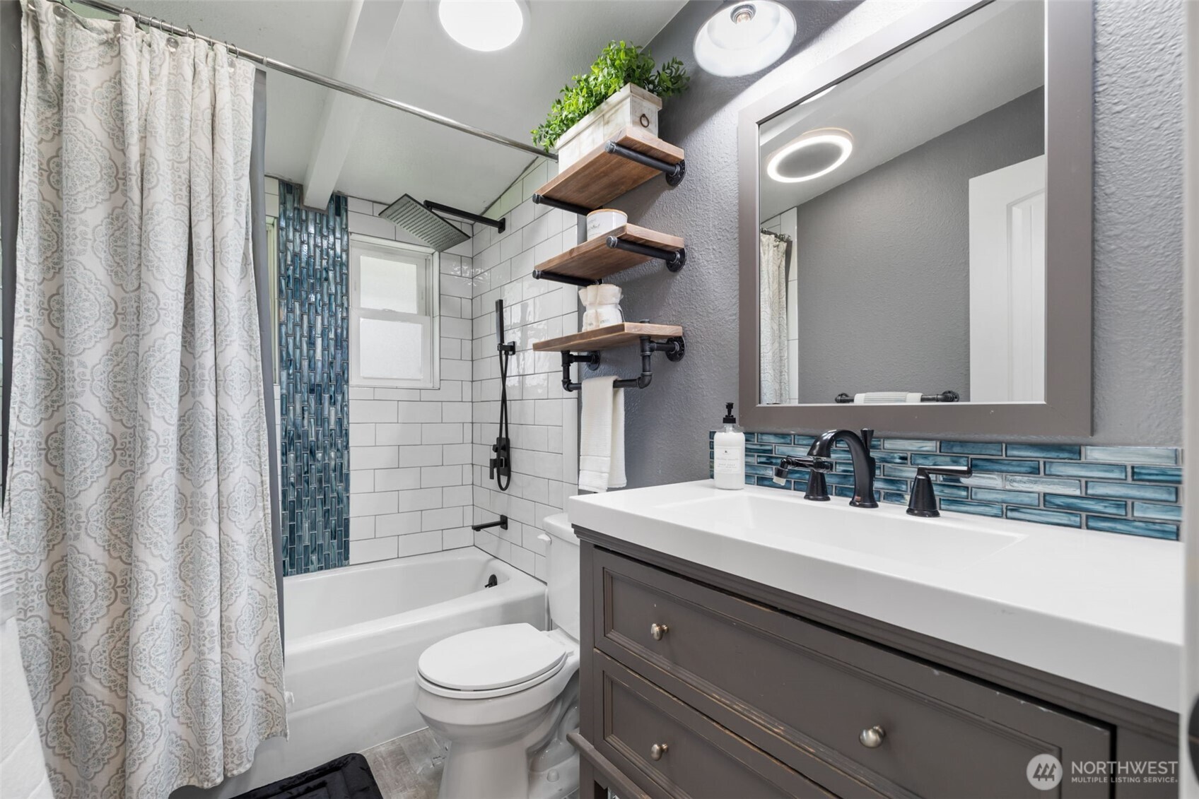 11782 Schold Road Northwest Silverdale, WA 98383 - Photo 15 of 40 a bathroom with a sink a toilet and shower