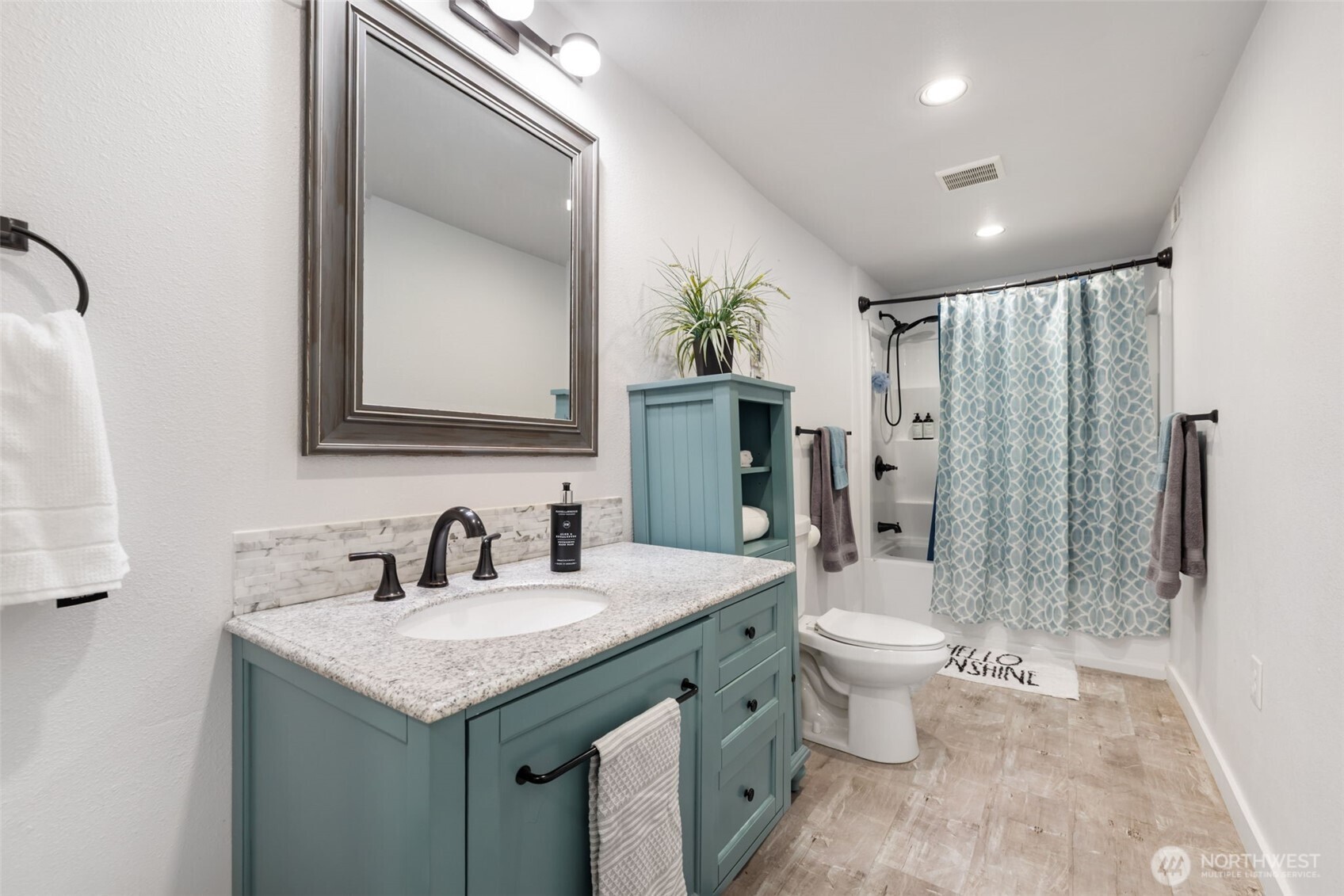 11782 Schold Road Northwest Silverdale, WA 98383 - Photo 25 of 40 a bathroom with a granite countertop sink a toilet a mirror a shower and vanity