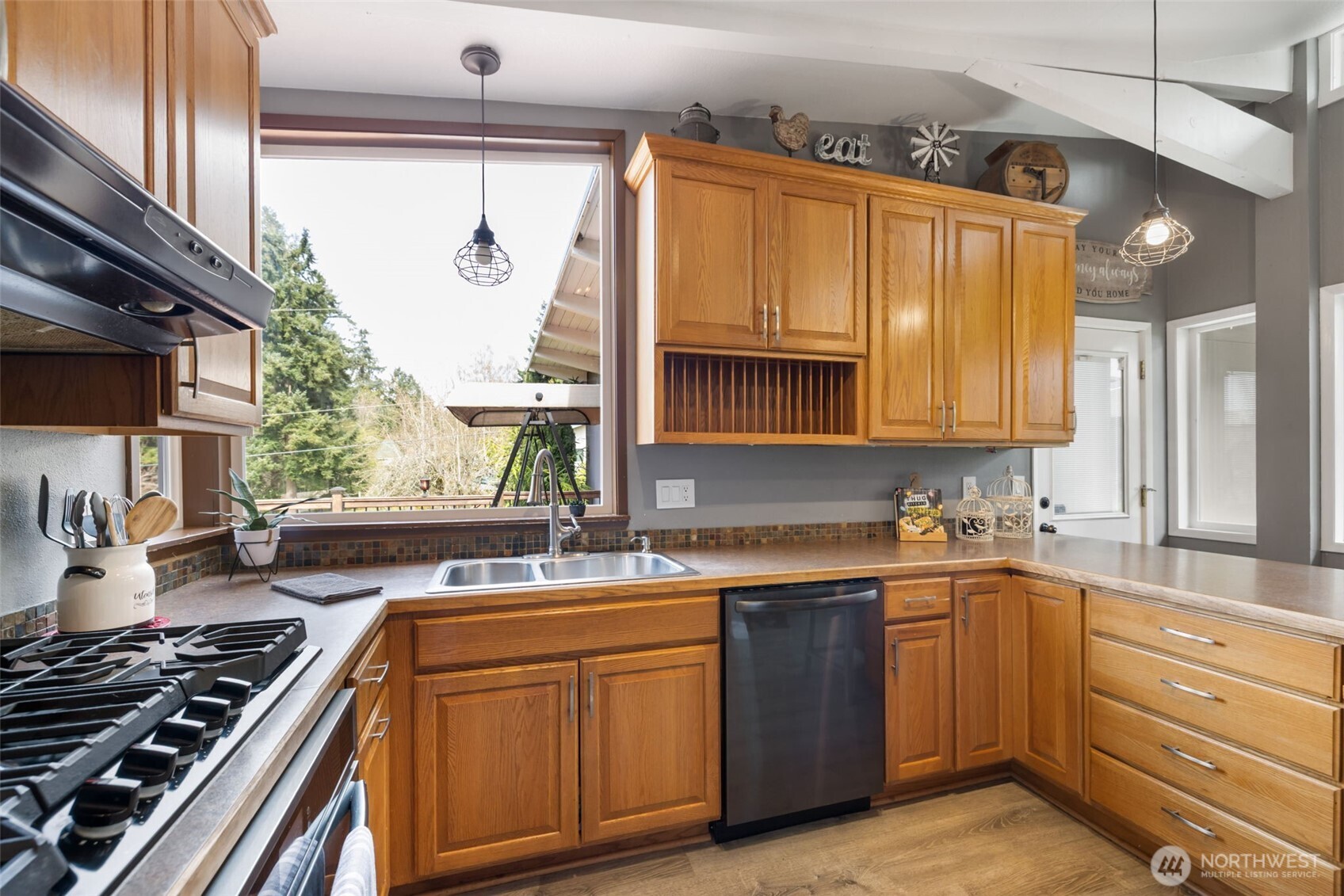 11782 Schold Road Northwest Silverdale, WA 98383 - Photo 6 of 40 a kitchen with a sink stove and cabinets