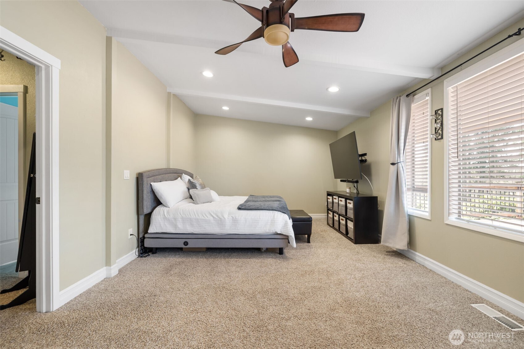 11782 Schold Road Northwest Silverdale, WA 98383 - Photo 9 of 40 a spacious bedroom with a bed and a chandelier