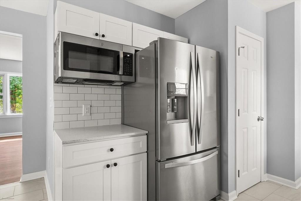 2763 Baker Ridge Drive Northwest Atlanta, GA 30318 - Photo 13 of 32 a metallic refrigerator freezer and a microwave