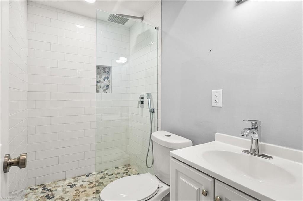 2763 Baker Ridge Drive Northwest Atlanta, GA 30318 - Photo 14 of 32 a bathroom with a sink toilet and shower