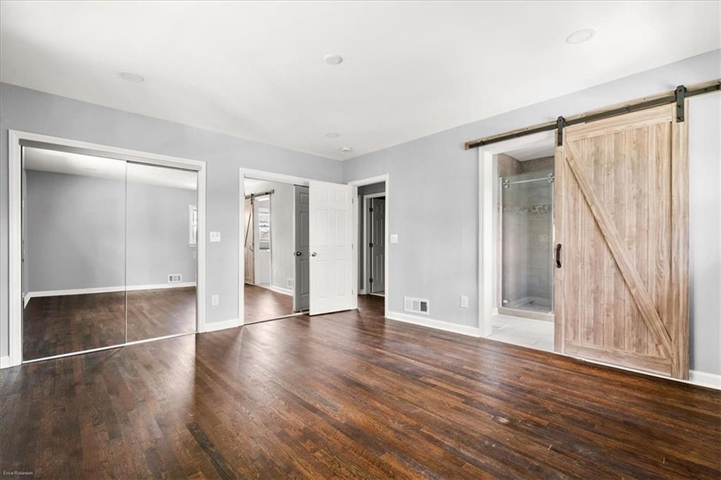 2763 Baker Ridge Drive Northwest Atlanta, GA 30318 - Photo 16 of 32 a view of an empty room with wooden floor and a window