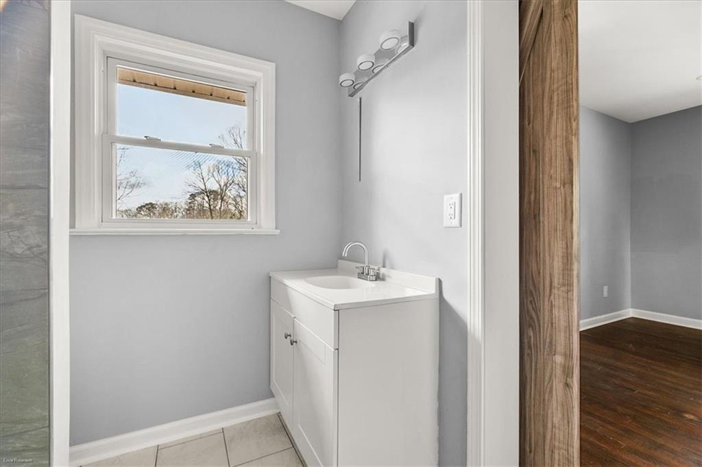 2763 Baker Ridge Drive Northwest Atlanta, GA 30318 - Photo 18 of 32 a bathroom with a sink a vanity and a mirror