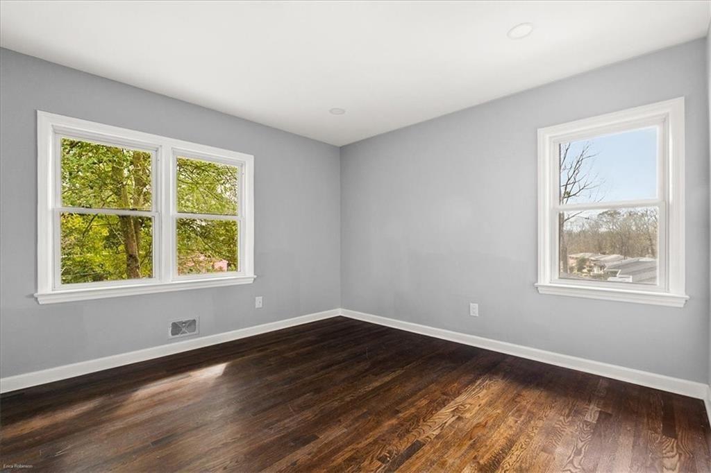 2763 Baker Ridge Drive Northwest Atlanta, GA 30318 - Photo 19 of 32 a view of an empty room with wooden floor and a window