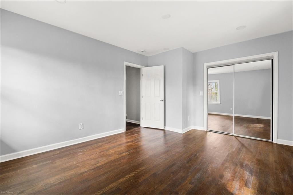 2763 Baker Ridge Drive Northwest Atlanta, GA 30318 - Photo 20 of 32 a view of an empty room with wooden floor