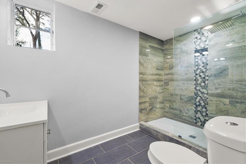 2763 Baker Ridge Drive Northwest Atlanta, GA 30318 - Photo 22 of 32 a white toilet sitting next to a bathroom sink