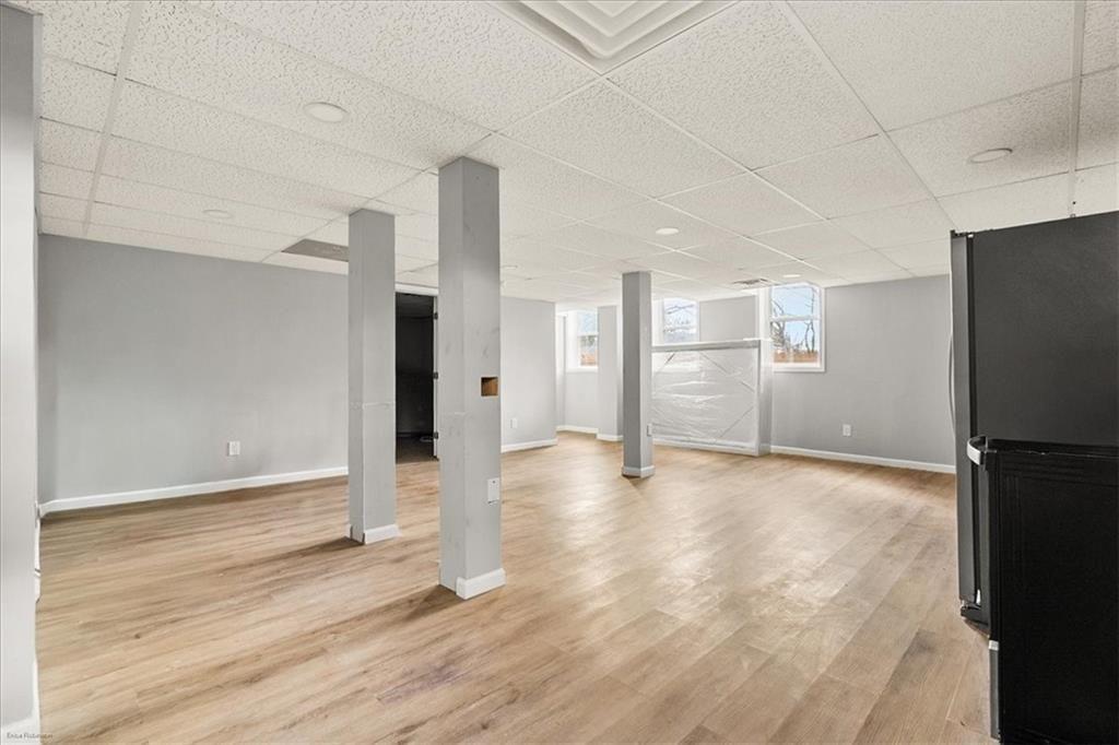 2763 Baker Ridge Drive Northwest Atlanta, GA 30318 - Photo 23 of 32 a view of a kitchen with a refrigerator and wooden floor