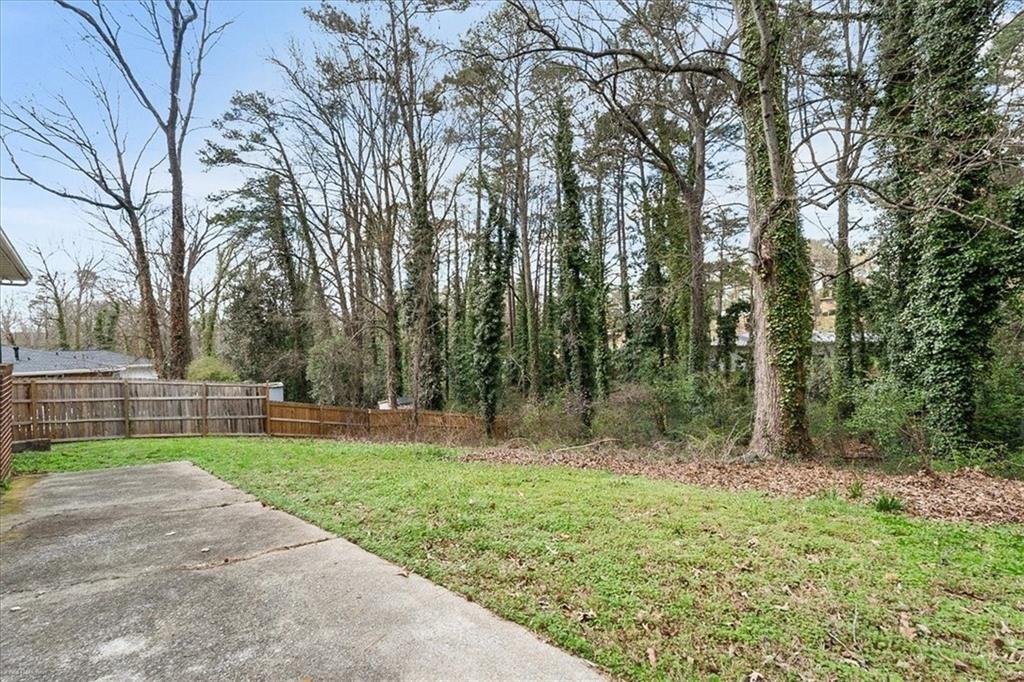 2763 Baker Ridge Drive Northwest Atlanta, GA 30318 - Photo 28 of 32 a backyard of a house with lots of green space