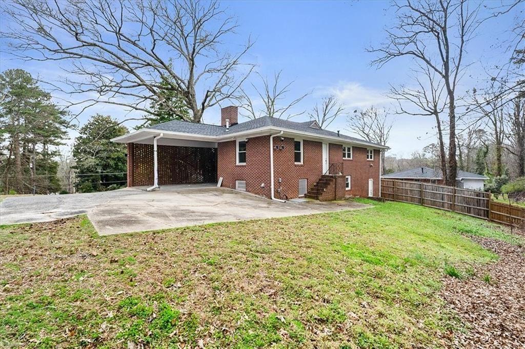 2763 Baker Ridge Drive Northwest Atlanta, GA 30318 - Photo 29 of 32 a front view of house with yard and green space