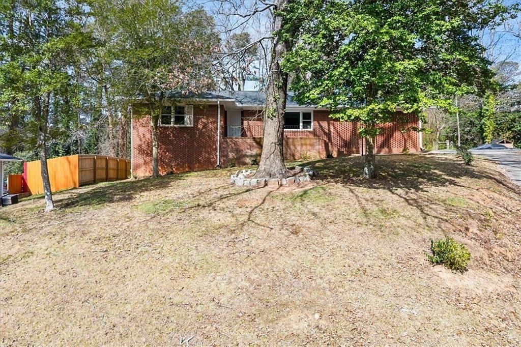 2763 Baker Ridge Drive Northwest Atlanta, GA 30318 - Photo 3 of 32 a view of house with backyard and trees