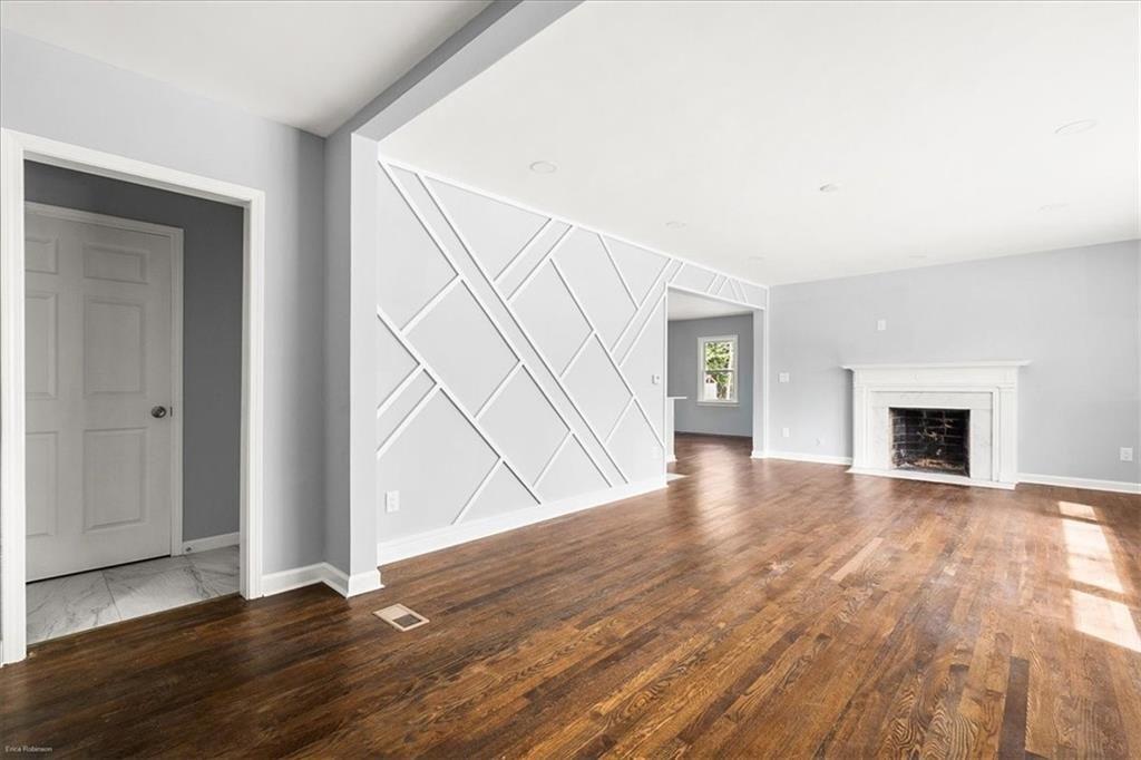 2763 Baker Ridge Drive Northwest Atlanta, GA 30318 - Photo 5 of 32 a view of an empty room with wooden floor and a window