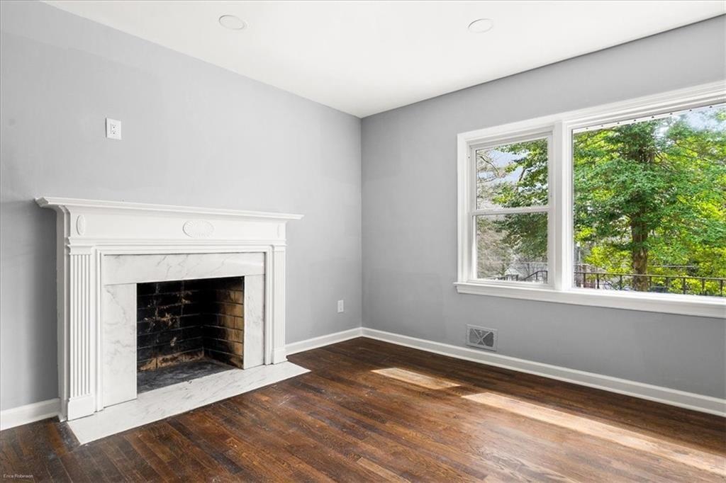 2763 Baker Ridge Drive Northwest Atlanta, GA 30318 - Photo 6 of 32 a view of an empty room with wooden floor and a window
