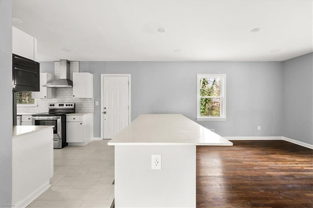 2763 Baker Ridge Drive Northwest Atlanta, GA 30318 - Photo 8 of 32 a view of a kitchen with microwave and cabinets