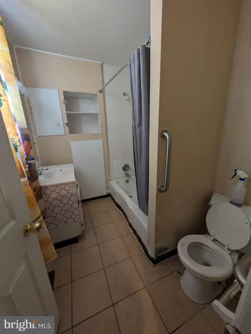 a bathroom with a toilet and a mirror