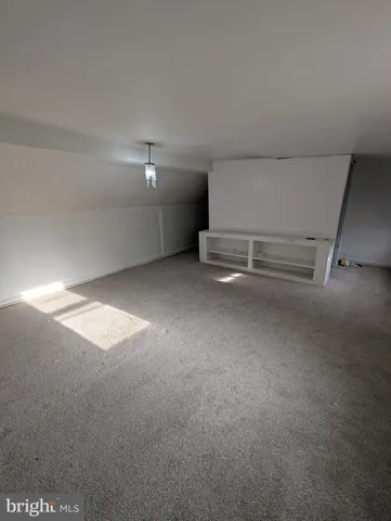 a view of an empty room with a fireplace