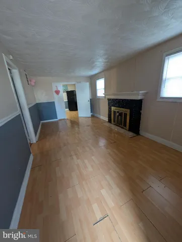 a view of a livingroom with an empty space and a window