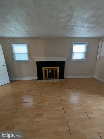 a view of empty room with a fireplace