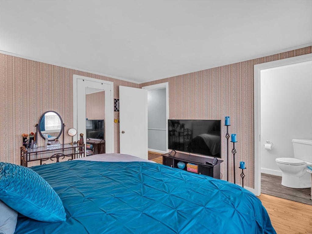 173 Bennett Road Hampden, MA 01036 - Photo 12 of 35 a bedroom with a bed and a flat screen tv