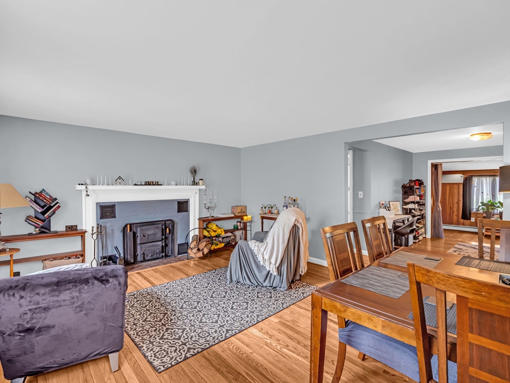 173 Bennett Road Hampden, MA 01036 - Photo 5 of 35 a living room with furniture a fireplace and a table