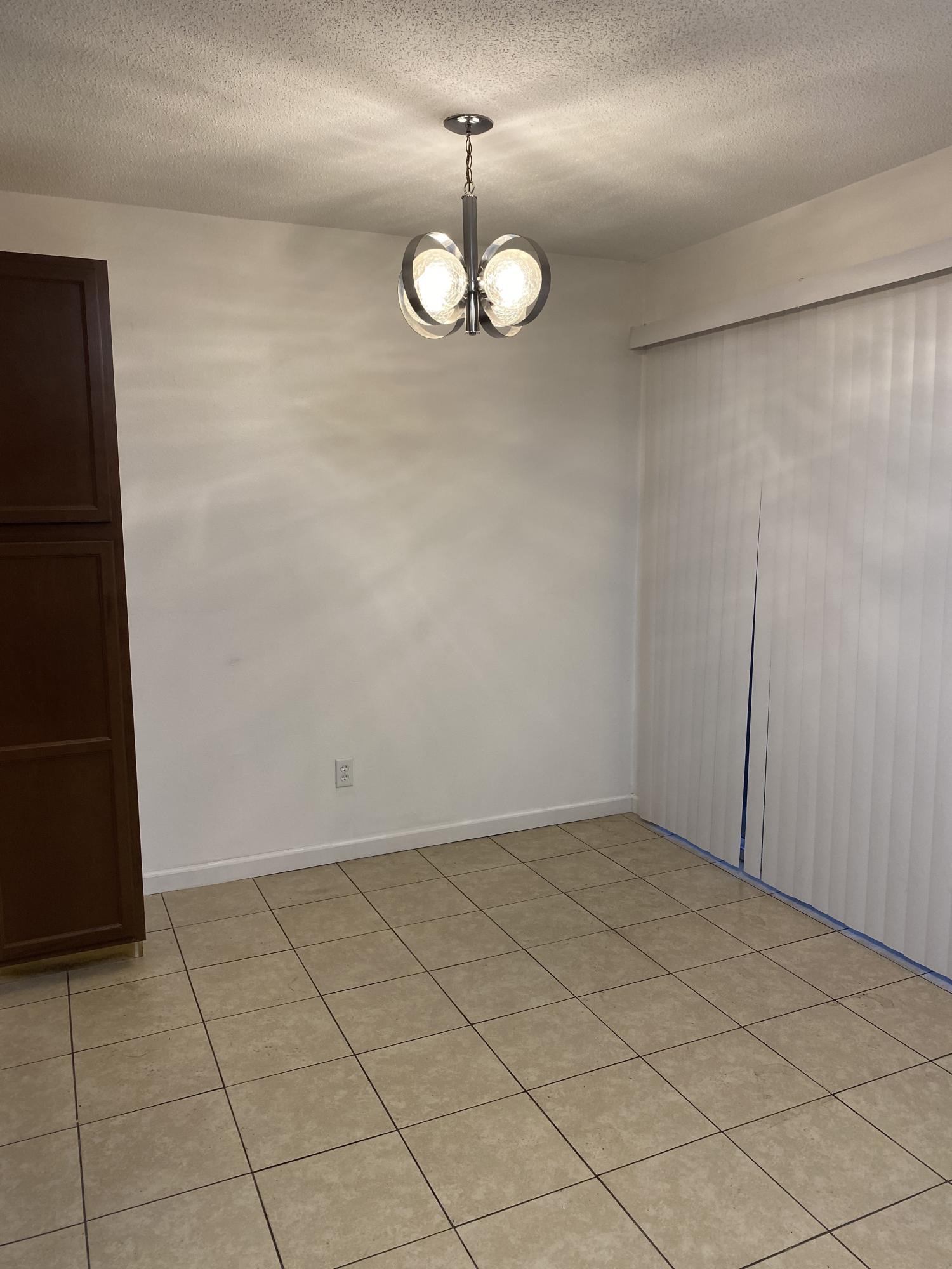 226 Pelham Road, Unit 6 Fort Walton Beach, FL 32547 - Photo 4 of 9 an empty room with chandelier fan