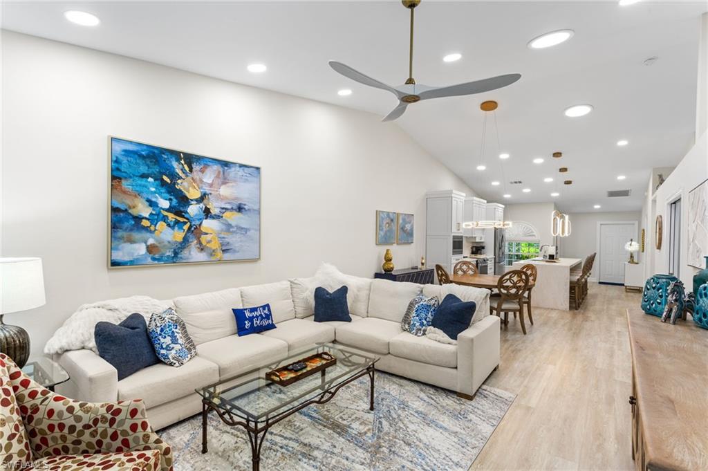 754 Wiggins Bay Drive Naples, FL 34110 - Photo 11 of 34 a living room with furniture kitchen view and a chandelier