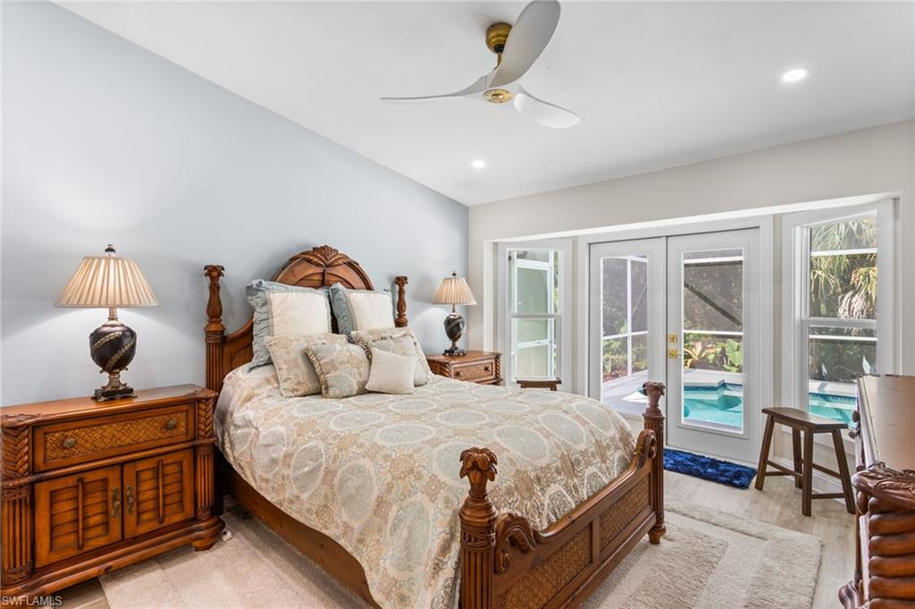 754 Wiggins Bay Drive Naples, FL 34110 - Photo 15 of 34 a bedroom with a large bed and windows