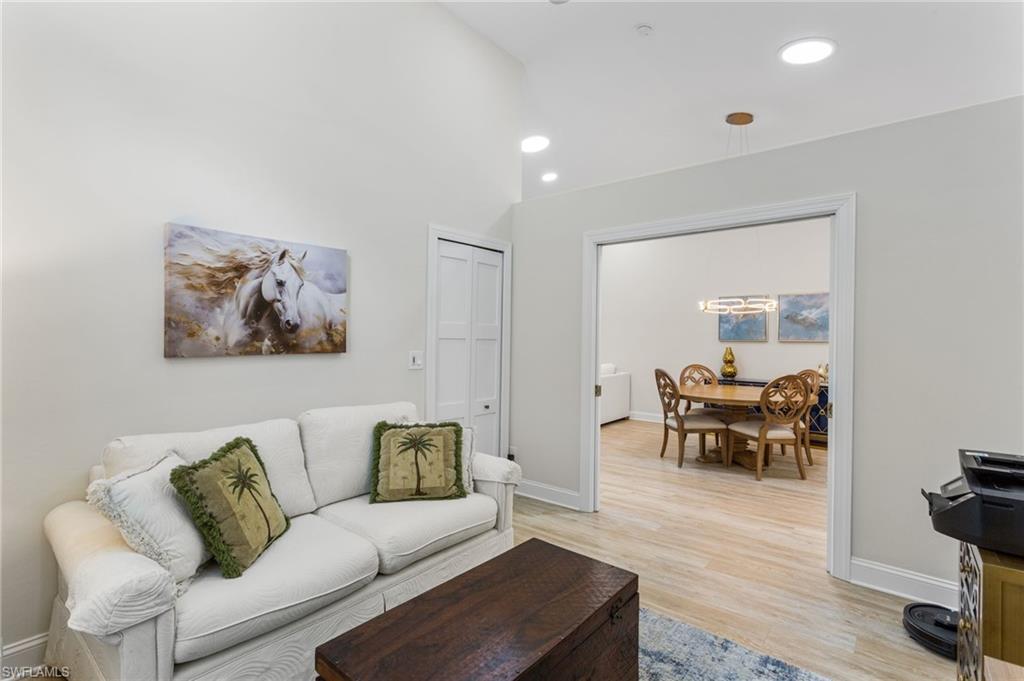 754 Wiggins Bay Drive Naples, FL 34110 - Photo 21 of 34 a living room with furniture and a wooden floor